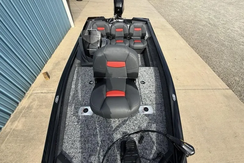 Slide: The Image of 2026 Tracker Pro Team 175 Crappie Edition boat with gray and red seating, docked outdoors. - 20