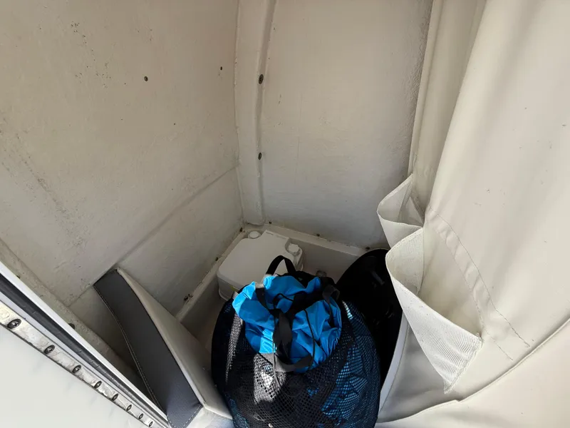 Slide: The Image of Interior of 2018 Tidewater 232 LXF boat with storage area and gear bag. - 14