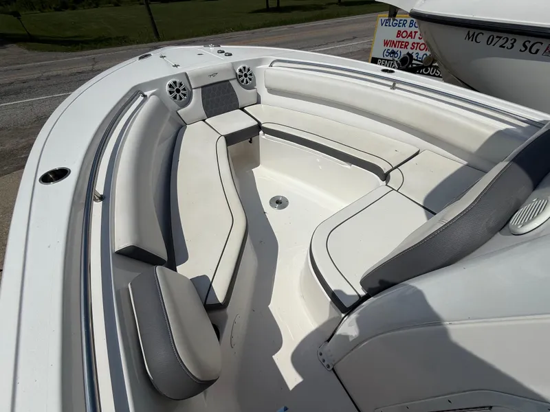 Slide: The Image of 2018 Tidewater 232 LXF boat interior with cushioned seating and speakers. - 15