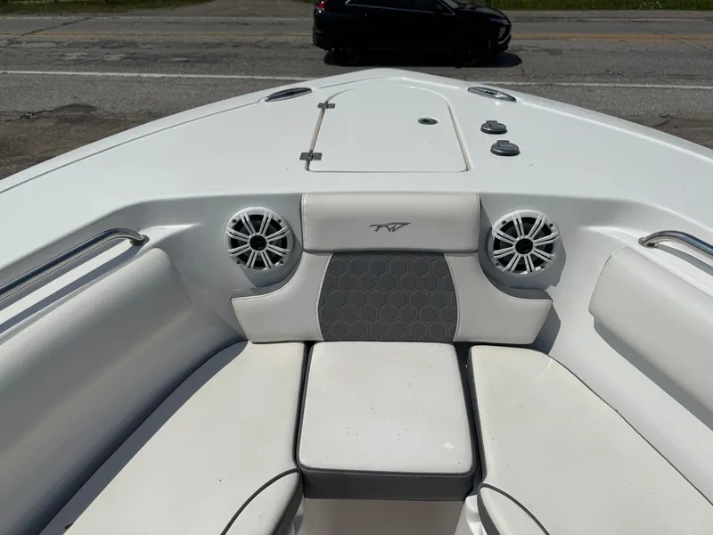 Slide: The Image of Bow seating area of a 2018 Tidewater 232 LXF boat with speakers and cushions. - 16