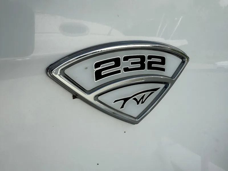 Slide: The Image of 2018 Tidewater 232 LXF boat emblem on white surface. - 20