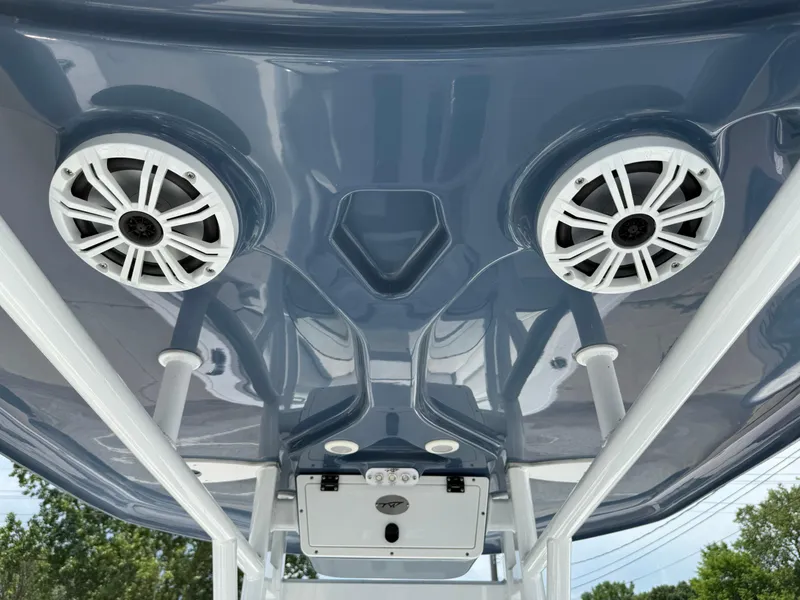Slide: The Image of 2018 Tidewater 232 LXF boat speakers and electronics on blue T-top. - 21
