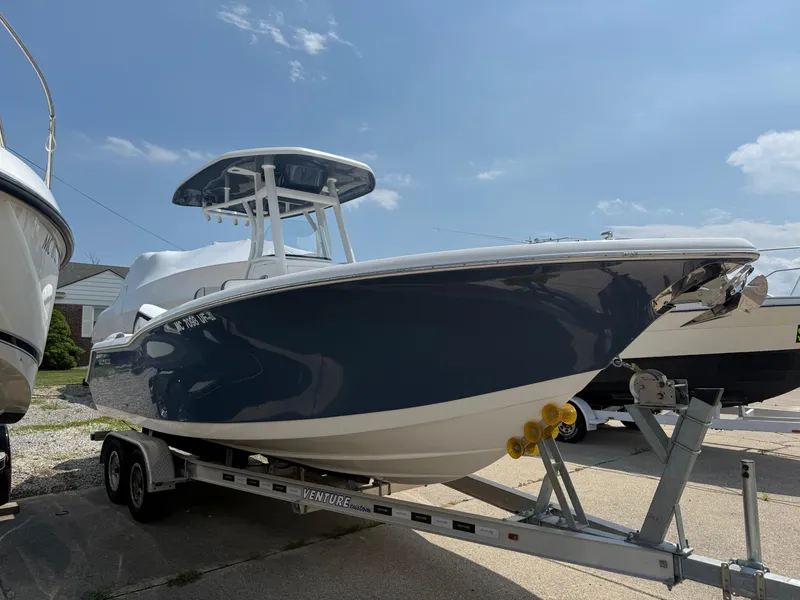 Slide: The Image of 2018 Tidewater 232 LXF boat on trailer under clear blue sky. - 5