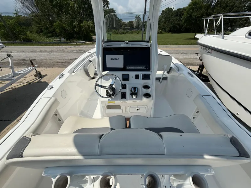 Slide: The Image of 2018 Tidewater 232 LXF boat interior with steering wheel and control panel. - 7