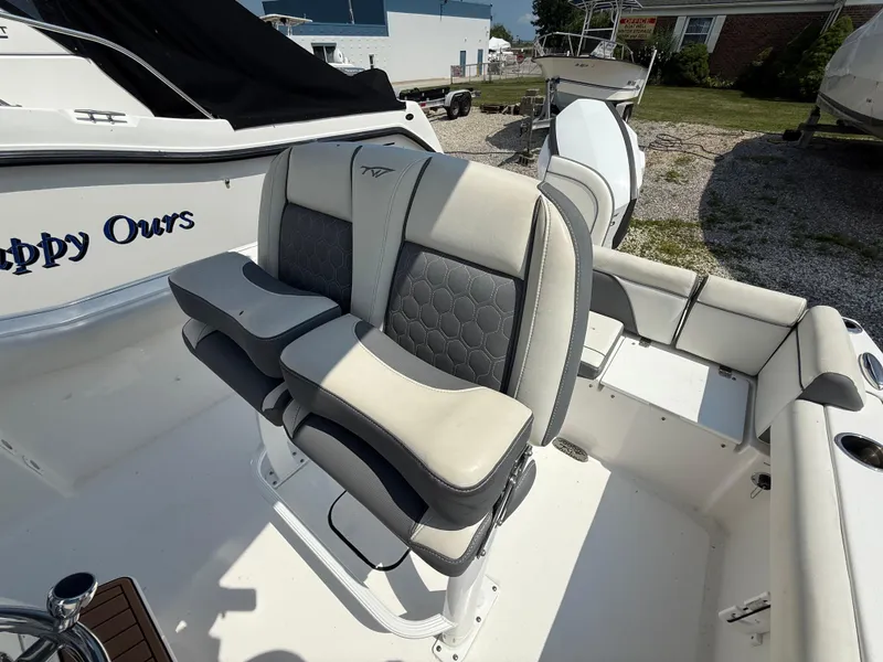 Slide: The Image of 2018 Tidewater 232 LXF boat with dual cushioned seats and sleek design. - 8