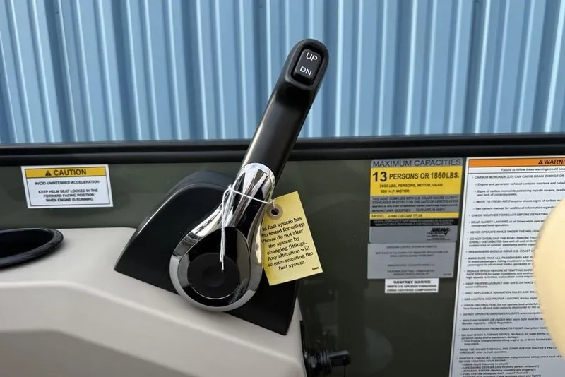 Slide: The Image of Throttle control and capacity labels on 2025 Godfrey Xperience 2286 SBX boat dashboard. - 12