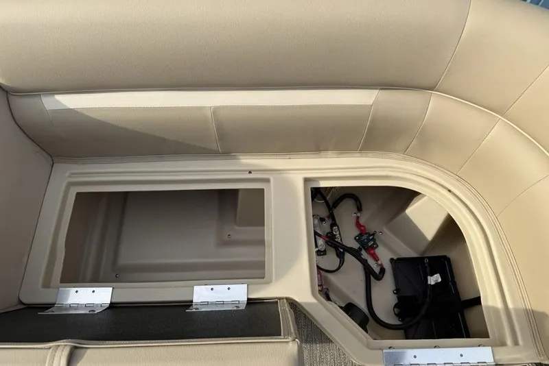 Slide: The Image of Interior storage compartment of 2025 Godfrey Xperience 2286 SBX boat, featuring beige seating. - 19