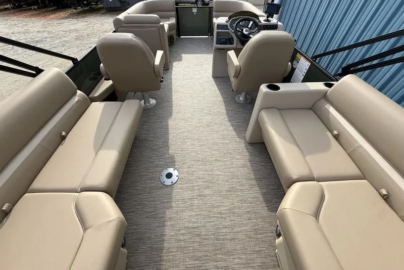 Slide: The Image of 2025 Godfrey Xperience 2286 SBX pontoon boat interior with beige seating and steering console. - 22