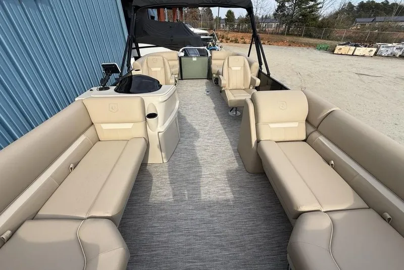 Slide: The Image of 2025 Godfrey Xperience 2286 SBX pontoon boat interior with beige seating and helm. - 24