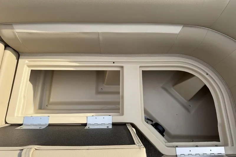 Slide: The Image of 2025 Godfrey Xperience 2286 SBX boat storage compartments with beige upholstery. - 7