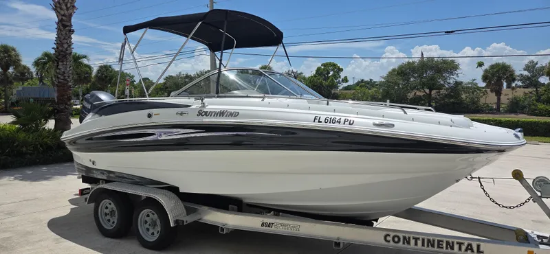The Image of 2011 SouthWind 2200 SD boat on trailer, parked outdoors under clear sky. - 0