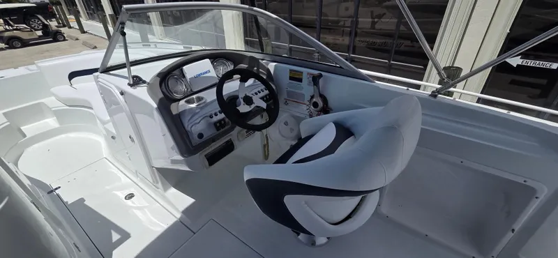 Slide: The Image of 2011 SouthWind 2200 SD boat cockpit with steering wheel and control panel. - 13