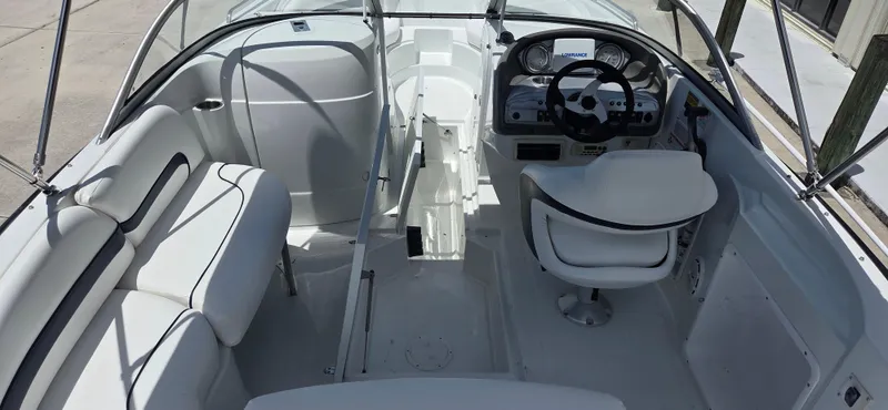 Slide: The Image of 2011 SouthWind 2200 SD boat interior with white seating and steering console. - 7