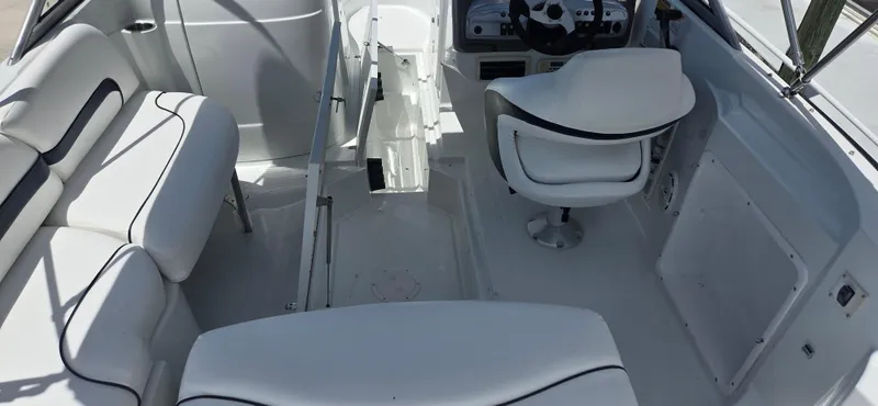 Slide: The Image of 2011 SouthWind 2200 SD boat interior with white seating and steering console. - 8