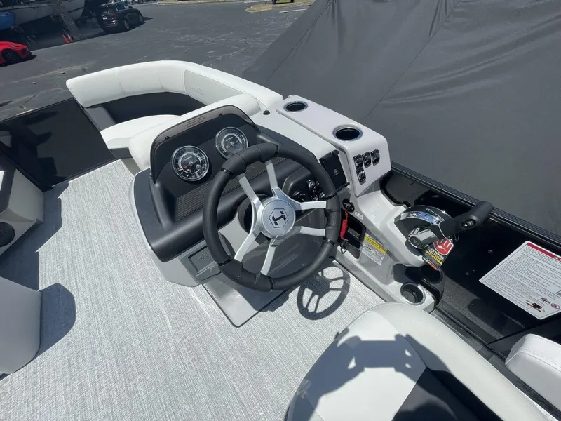 Slide: The Image of 2026 Harris Cruiser 210 boat dashboard with steering wheel and control panel. - 6
