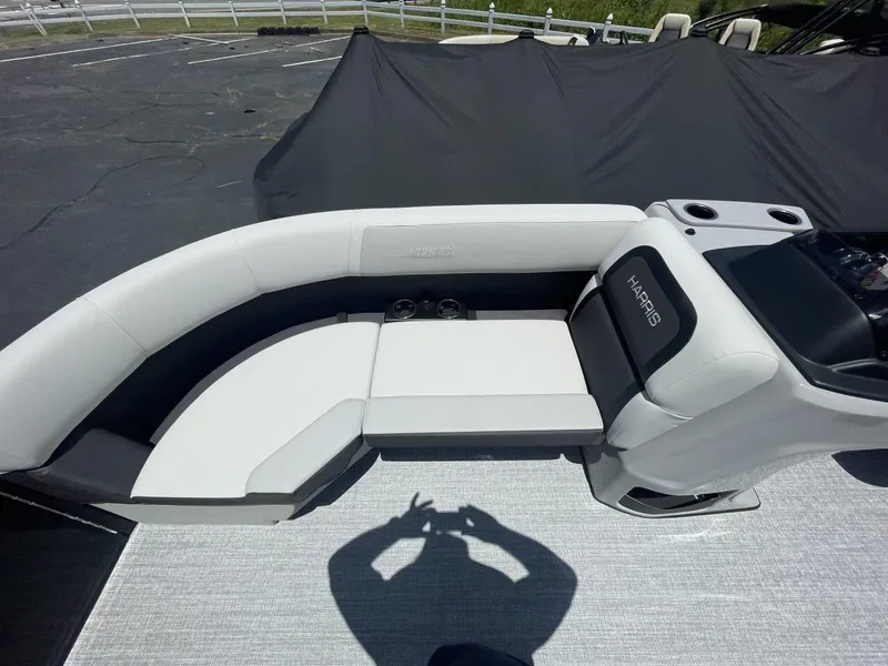 Slide: The Image of 2026 Harris Cruiser 210 boat interior with white seating and cup holders. - 8