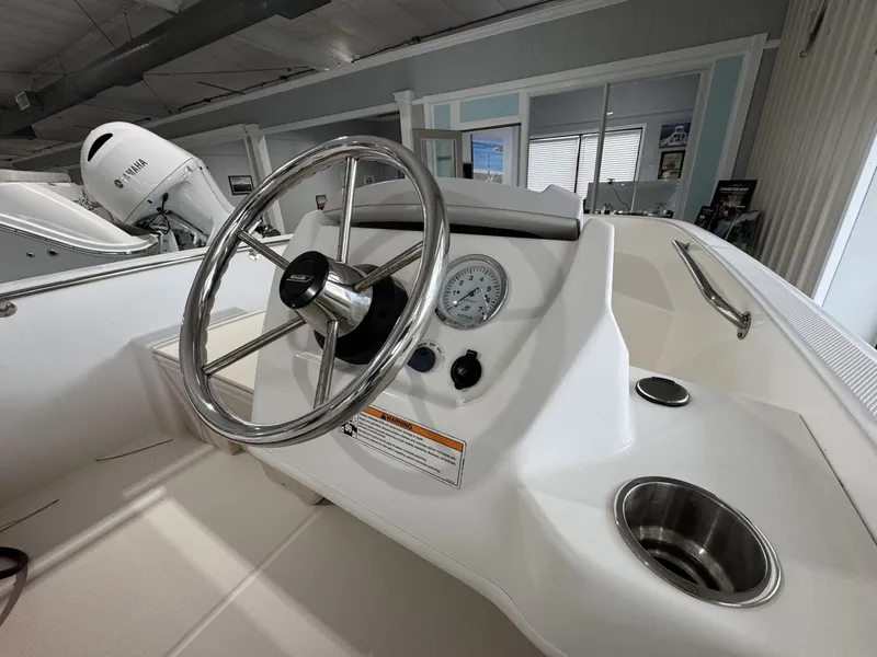 Slide: The Image of 2023 Boston Whaler 160 Super Sport steering console with stainless steel wheel and gauge. - 10