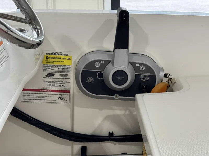 Slide: The Image of 2023 Boston Whaler 160 Super Sport throttle control and capacity label. - 13