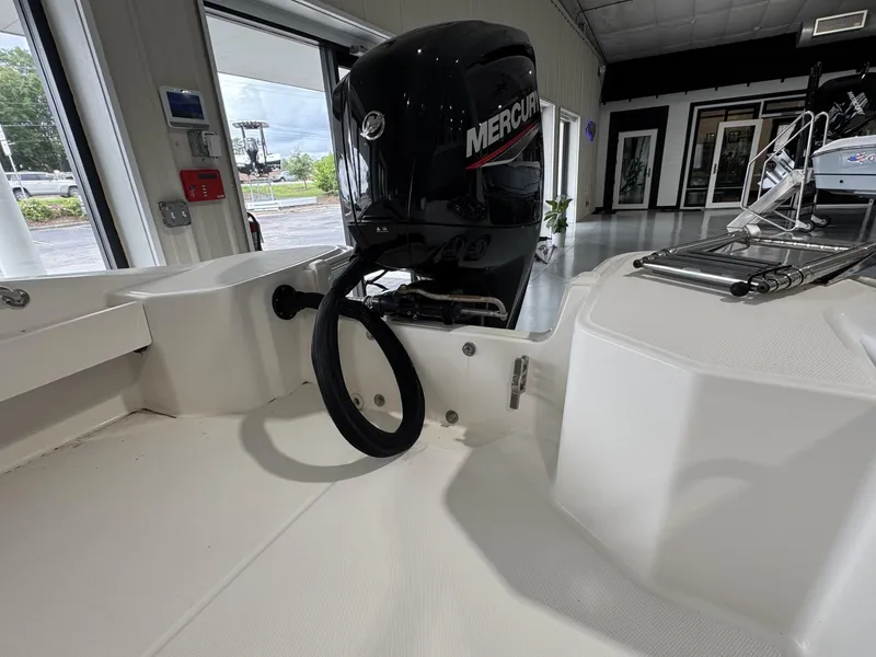Slide: The Image of 2023 Boston Whaler 160 Super Sport with Mercury outboard engine in showroom. - 15