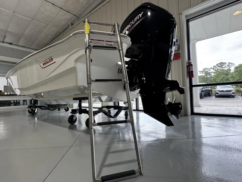 Slide: The Image of 2023 Boston Whaler 160 Super Sport boat with Mercury engine in showroom. - 16