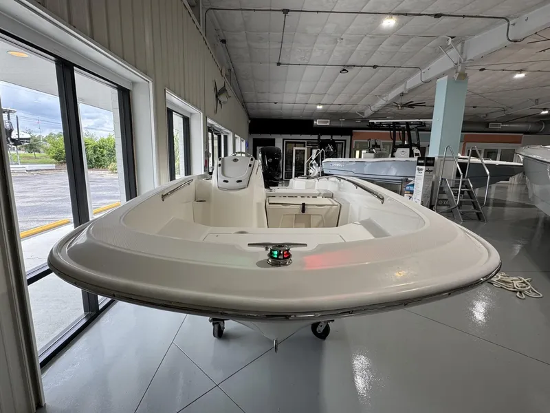 Slide: The Image of 2023 Boston Whaler 160 Super Sport boat displayed in a showroom. - 3