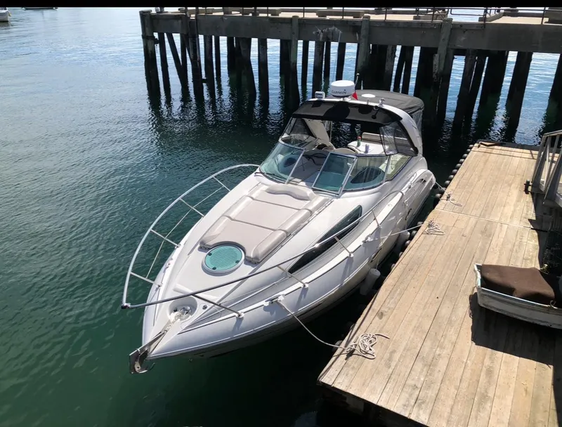 Slide: The Image of 2003 Doral 330 Elegante CR boat docked at a wooden pier. - 1