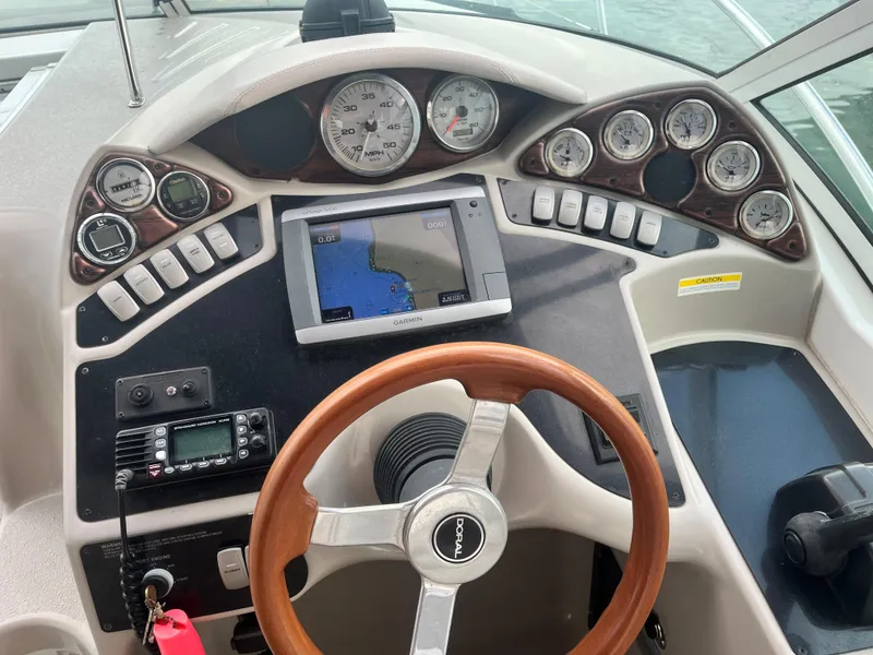Slide: The Image of Cockpit of 2003 Doral 330 Elegante CR with steering wheel, gauges, and navigation system. - 2