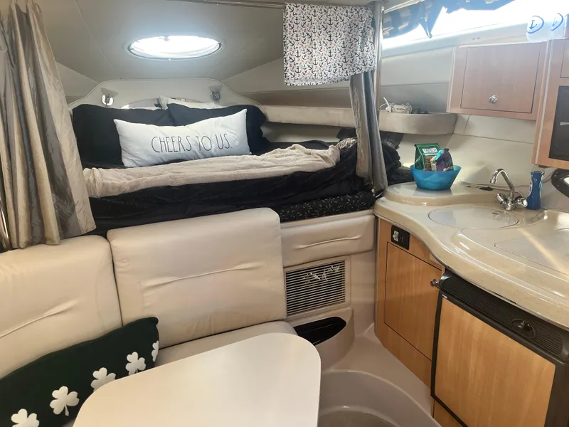 Slide: The Image of Interior of 2003 Doral 330 Elegante CR boat with cozy seating and kitchenette. - 3
