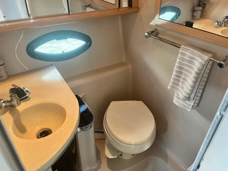 Slide: The Image of Compact bathroom in 2003 Doral 330 Elegante CR yacht with sink, toilet, and towel rack. - 6