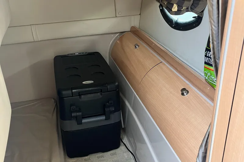 Slide: The Image of Interior of 2003 Doral 330 Elegante CR with compact fridge and wooden cabinetry. - 8