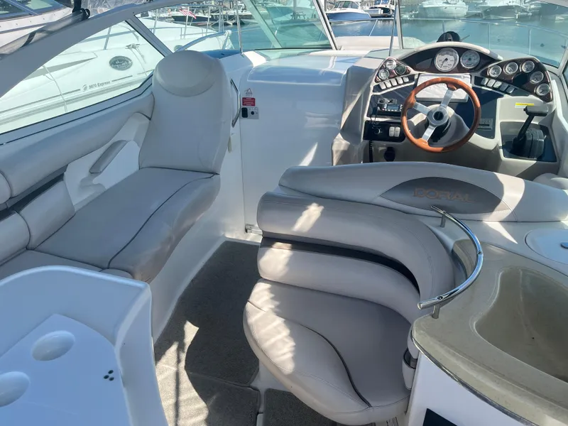 Slide: The Image of 2003 Doral 330 Elegante CR boat interior with plush seating and modern dashboard. - 9