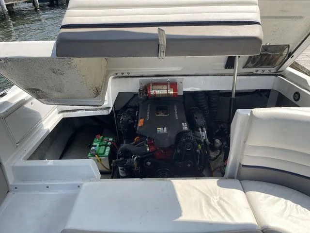 Slide: The Image of Open engine compartment of a 2004 Cobalt 226 boat, showing engine and seating area. - 14