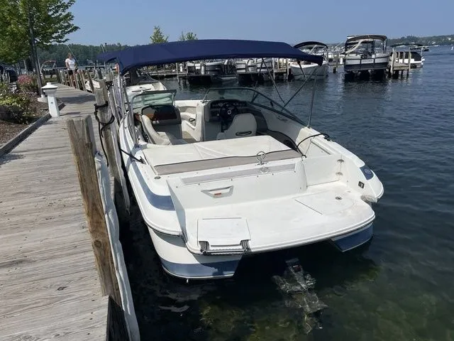 Slide: The Image of 2004 Cobalt 226 boat docked at a marina with blue canopy. - 3