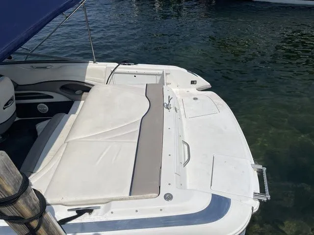 Slide: The Image of 2004 Cobalt 226 boat with cushioned seating, docked on calm water. - 4