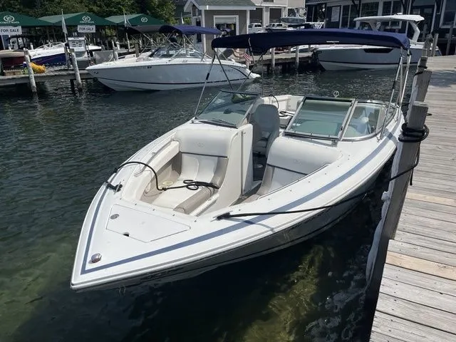 Slide: The Image of 2004 Cobalt 226 boat docked at marina, featuring sleek design and spacious seating. - 5