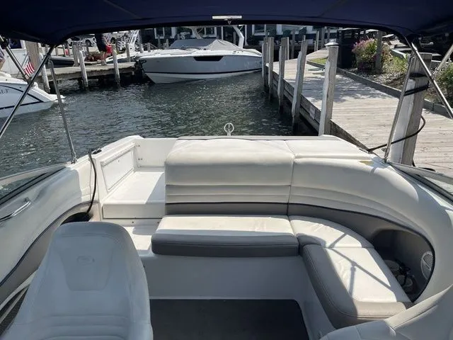 Slide: The Image of 2004 Cobalt 226 boat interior with white seating, docked at a marina. - 7