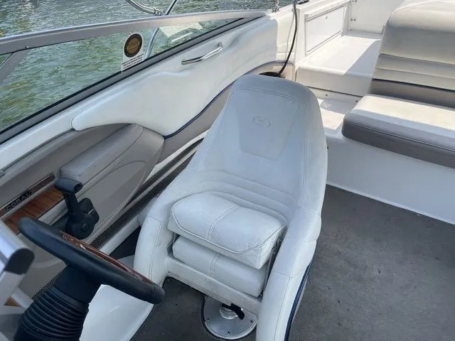 Slide: The Image of Interior of a 2004 Cobalt 226 boat with white seating and steering wheel. - 8