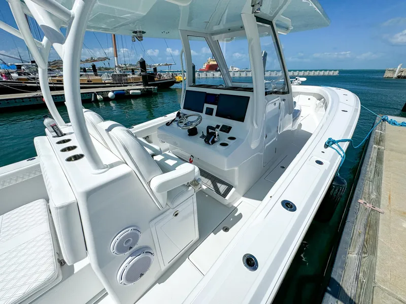 Slide: The Image of 2025 Front Runner 36 cc boat docked, featuring a sleek white interior and advanced navigation controls. - 11