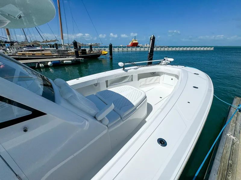 Slide: The Image of 2025 Front Runner 36 cc boat docked at marina under clear blue sky. - 14