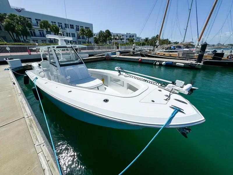 Slide: The Image of 2025 Front Runner 36 cc boat docked in marina, clear blue water, sunny day. - 16