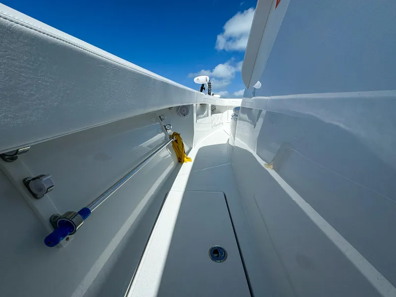 Slide: The Image of 2025 Front Runner 36 cc boat interior with sleek white design under blue sky. - 18