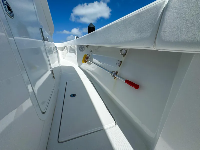 Slide: The Image of 2025 Front Runner 36 cc boat interior with storage compartments and clear blue sky. - 20