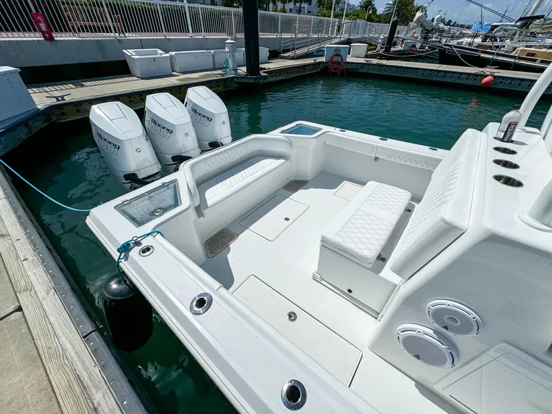 Slide: The Image of 2025 Front Runner 36 cc boat docked, featuring triple outboard engines and spacious seating. - 7