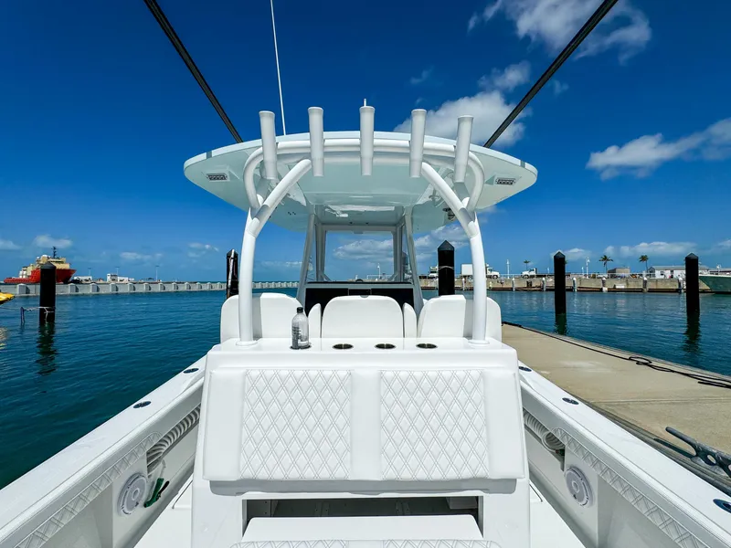 Slide: The Image of 2025 Front Runner 36 cc boat docked at marina under clear blue sky. - 8