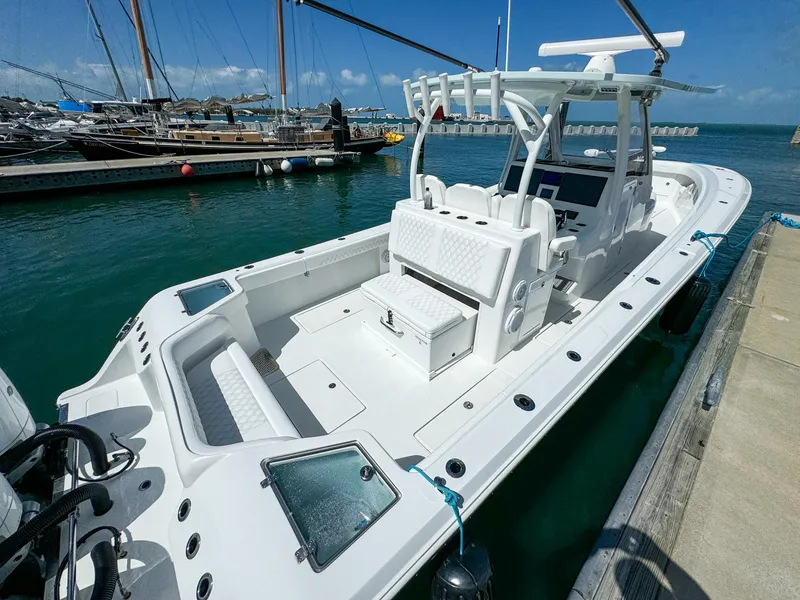 Slide: The Image of 2025 Front Runner 36 cc boat docked at marina, featuring sleek design and spacious deck. - 9