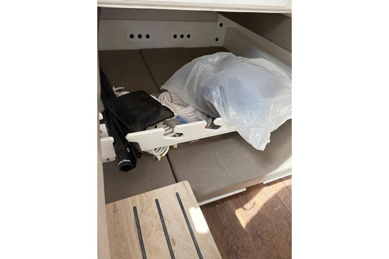 Slide: The Image of Storage compartment in 2026 Regulator 35 boat, containing ropes and equipment. - 13