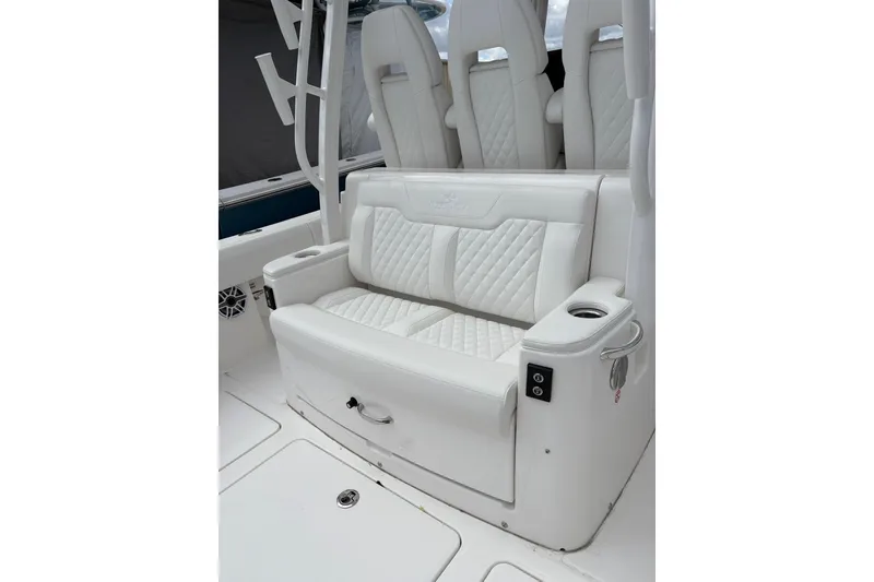 Slide: The Image of Luxurious white seating on 2026 Regulator 35 boat, featuring quilted upholstery and cup holder. - 20