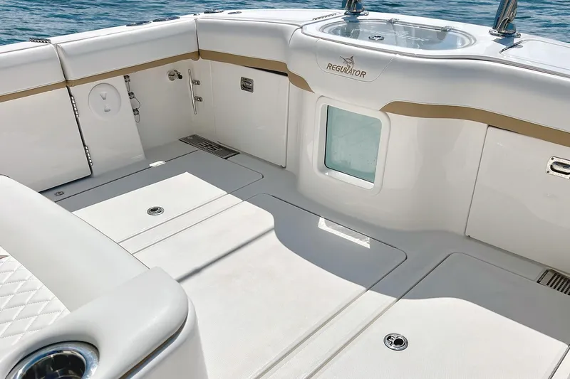 Slide: The Image of 2026 Regulator 35 boat interior with sleek white design and ocean backdrop. - 4