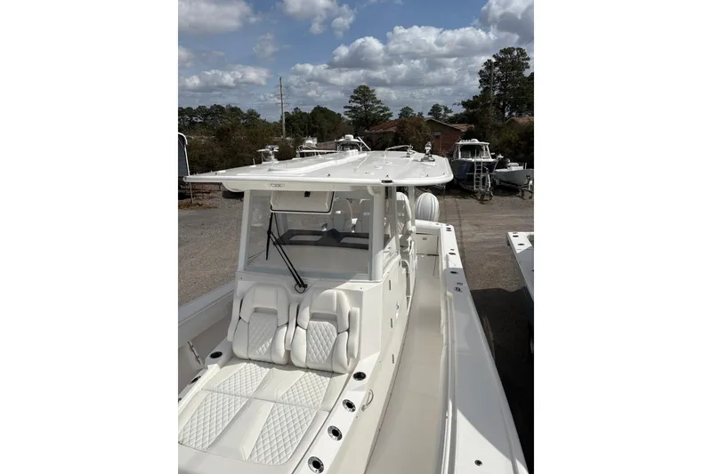Slide: The Image of 2026 Regulator 35 boat with sleek design and comfortable seating under a cloudy sky. - 9