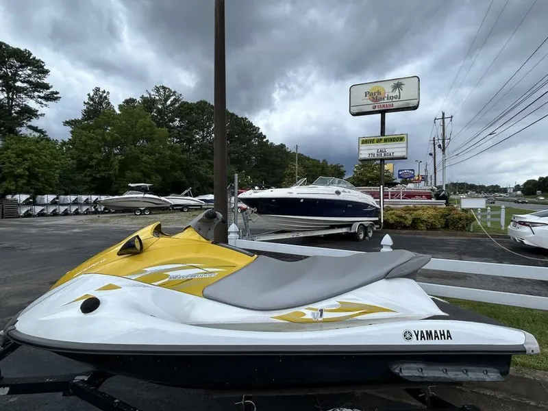 The Image of 2016 Yamaha WaveRunner VX jet ski in dealership lot under cloudy sky. - 1